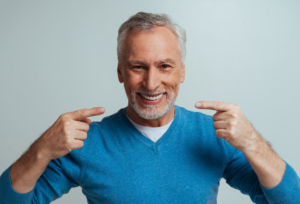 a patient with dentures smiling brightly 